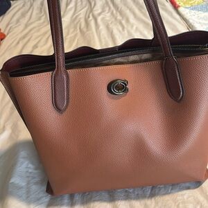 Tan Coach purse with zipper laptop compartment and two other compartments,
